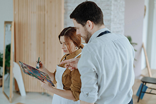 Two colleagues reviewing a document or design plan together while discussing details